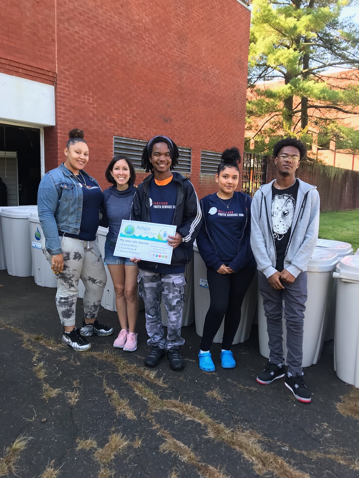 Youth Service Corps Members help give out rain barrels