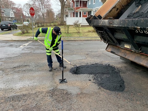 DPW Worker filling a pothole