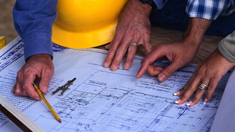 A depiction of the engineering department with hands on a floor plan
